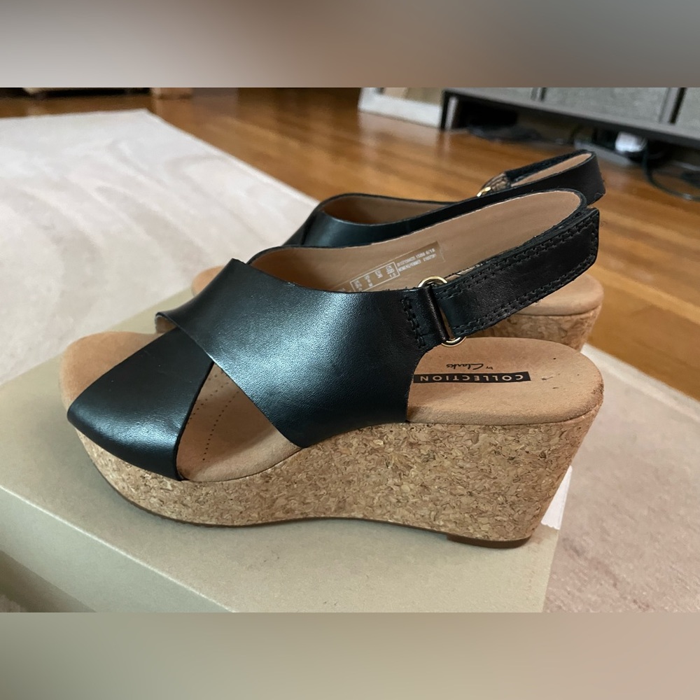 Clarks brand Annadel Eirwyn black leather platform sandals with cork heel.